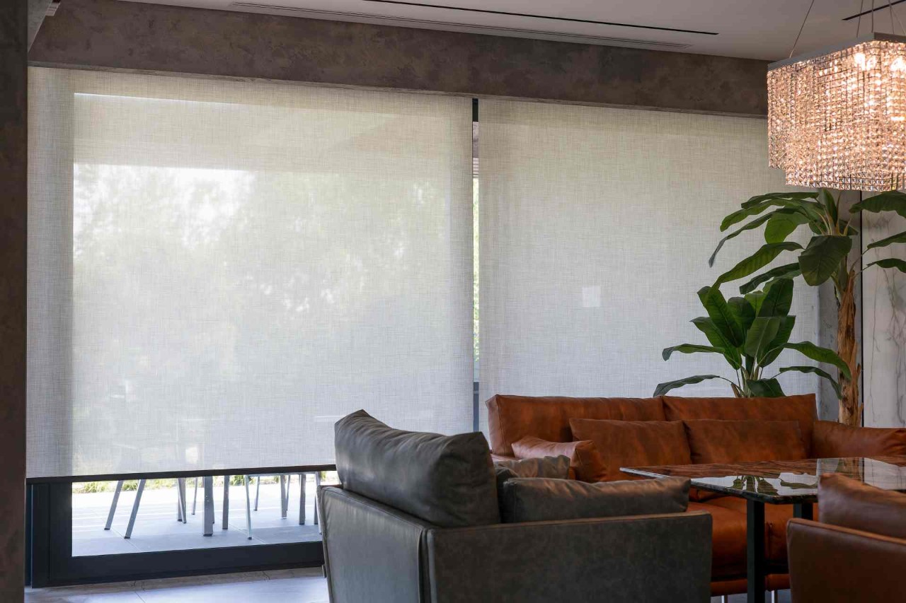 Solar shades on a window in a waiting room for a business at All About The Windows near Mobile, Alabama